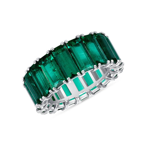 Natural emerald eternity band on a white background