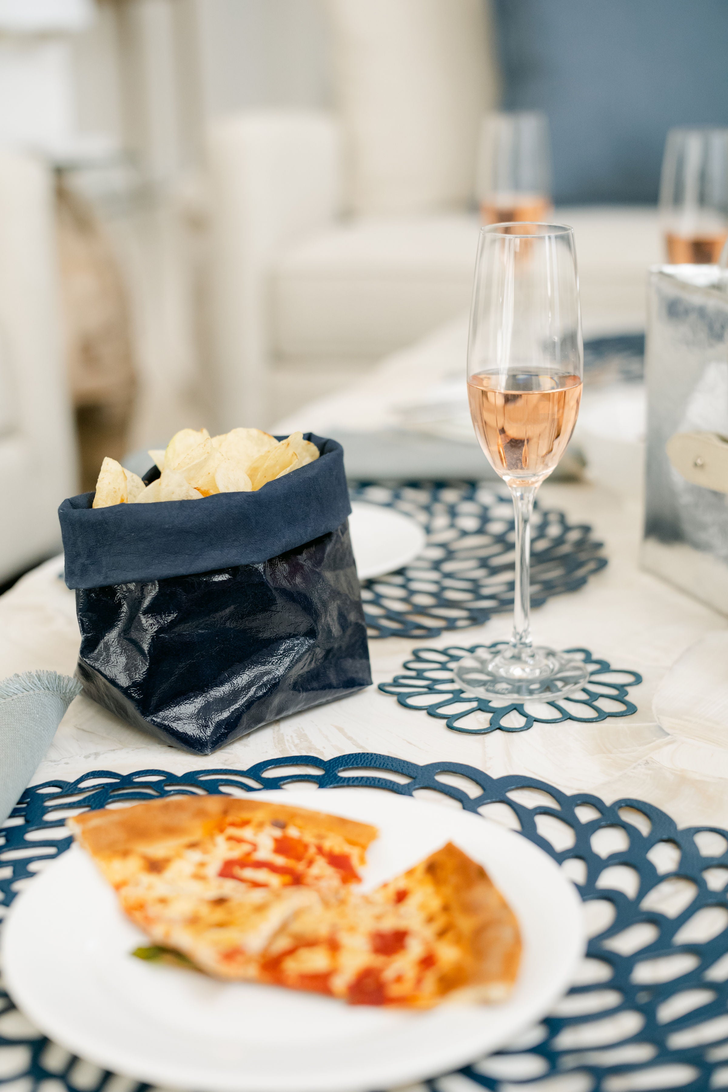 Glossy Paper Bag on dining table with pizza and wine
