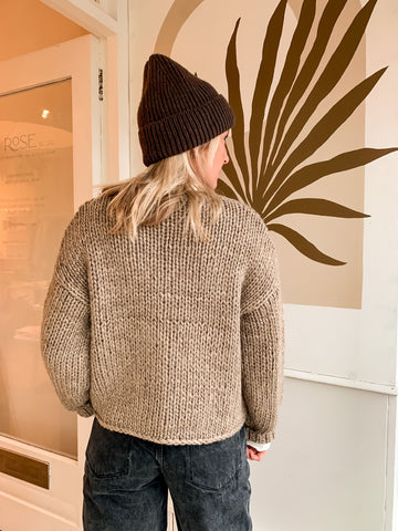 Nat wears the OBJECT chunky cropped hand-knitted cardigan and chunky ribbed beanie hat in dark earth.