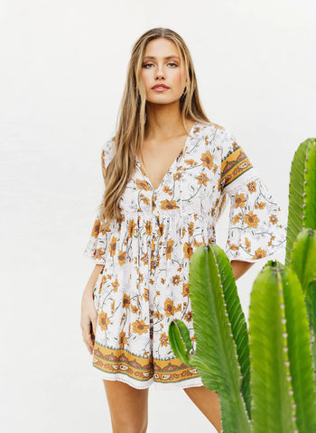 This floral playsuit has dreamy fluted 3/4 length sleeves with a button through v neck and crochet details. A feminine and  flirty style which looks fab thrown over a bathing suit or great worn out and about with gladiator sandals.