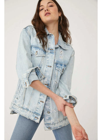 Cool and forever classic, this effortless denim trucker jacket is featured in an oversized, slouchy silhouette with subtle distressing throughout for the perfect lived-in look.