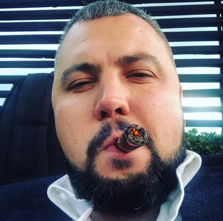 Pablo smoking his first cigar.jpg__PID:6a1edca0-f190-43c0-b718-02bb81f63e13