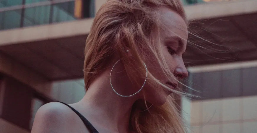 a girl wearing hoop earrings