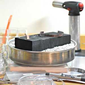 A jewelry studio workbench with all the appropriate tools sitting on top.