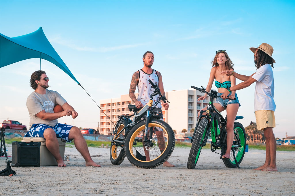 Group of men and women riding electric bikes on the beach.-0824