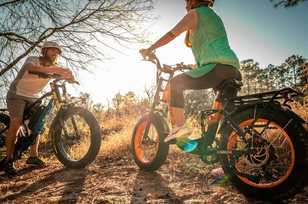 Couple of man and woman riding electric bike on mountain.-1107