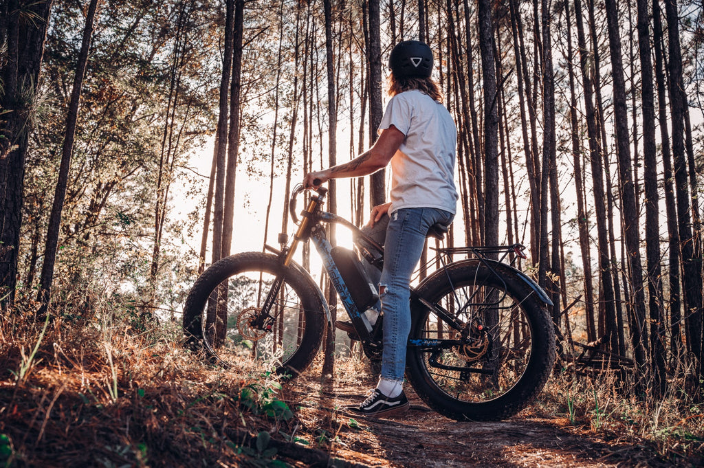 A man rides an electric bike in the forest.-0826