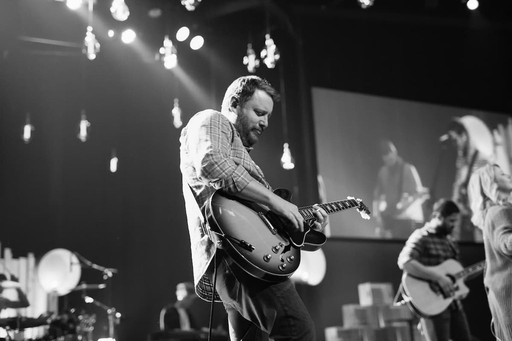 a guitarist performing live on stage