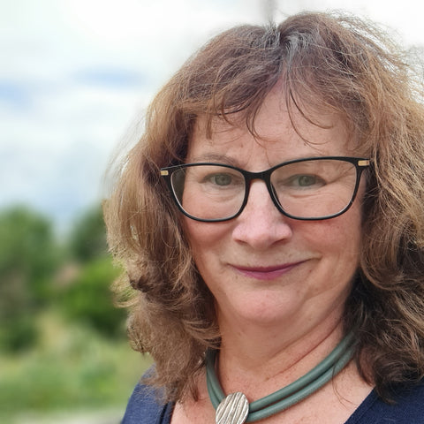 Kent jeweller, Charlotte Tabor from Kara Jewellery wearing glasses and a leather and silver necklace