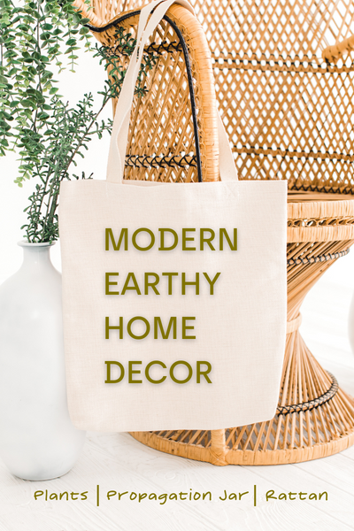 modern earthy home decor on a bag hanging on an ornate rattan peacock chair with foliage in a propagation jar