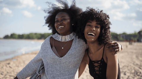 Two black women with high and low porosity hair 