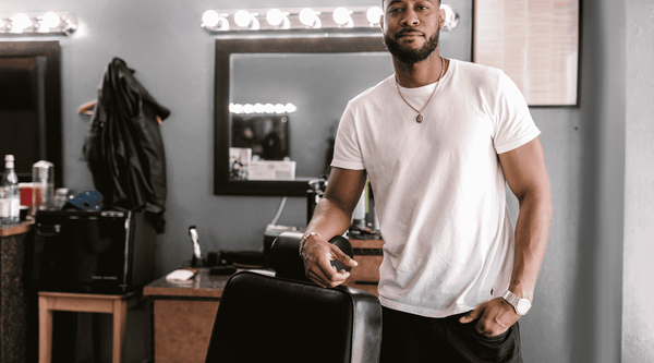 Black Barber Standing By His Chair