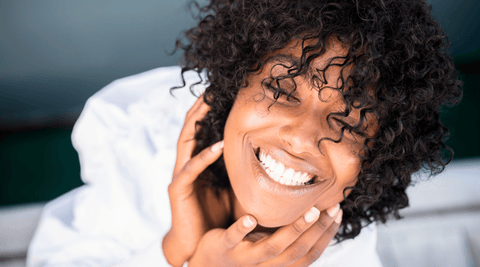Black Woman Happy B/c she No longer has dandruff and uses natural remedies.