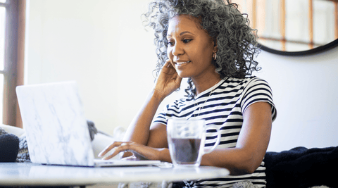 African-American/Black Woman Researching the Best Anti-Aging Creams with Jojoba Oil and Rosehip Oil