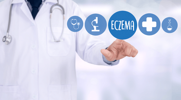 Image of doctor pointing to the word eczema in a blue bubble. 