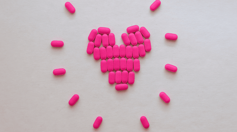 Image of a bunch of pink Benadryl tablets.