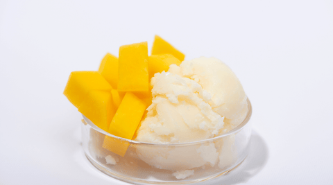 Pure White Unrefined Mango Butter in a Clear Bowl for Anti-Aging Creams and Moisturizers