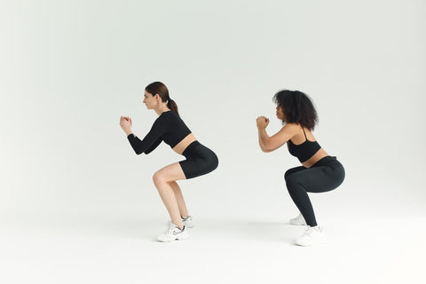 Two women doing squat exercises