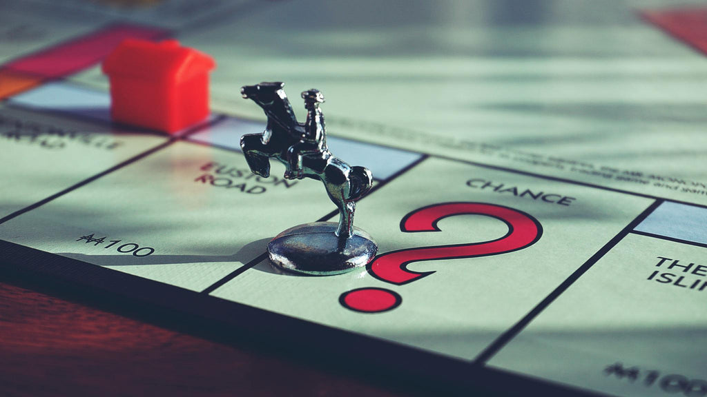 Close up shot of a Monopoly board with a player figurine on the board