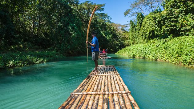 People on Bamboo Boats Enjoying Jamaica's Ecotourism 