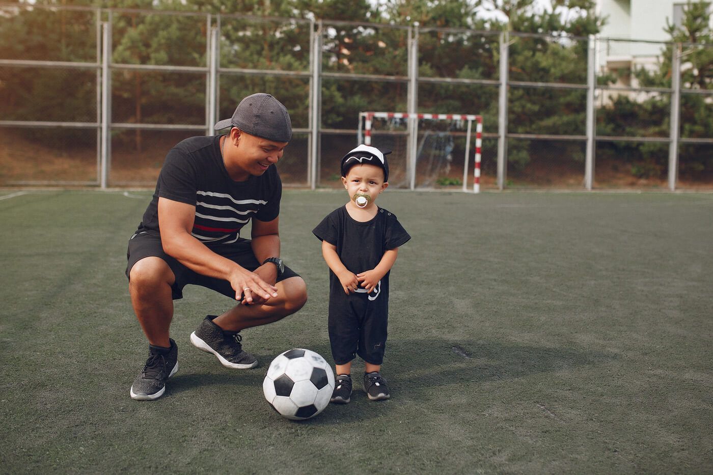 father and son on a field learning soccer
