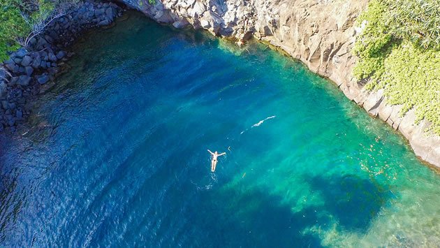 Woman Swimming in a Maui Waterfall 