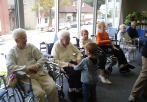 Young Boy Greeting Elders at a Nursing Home 