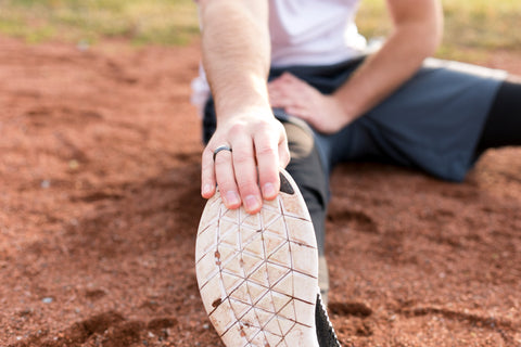 Man stretching in the sand