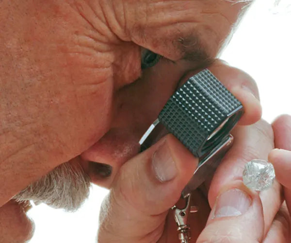 Jeweler looking at ring with loop