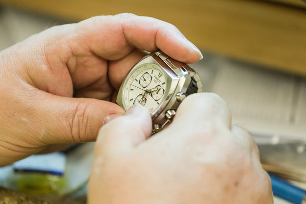 Dealer looking at watch