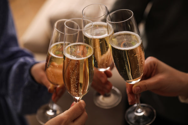 People clinking glasses with champagne at home