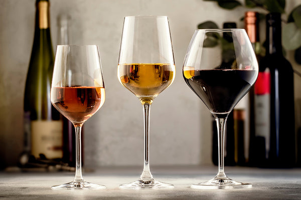 Wines assortment of red, white and rose wine in glasses and bottles