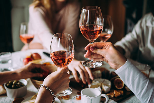 People holding glasses of Rosé wine at home