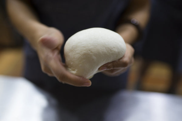 Person holding dough