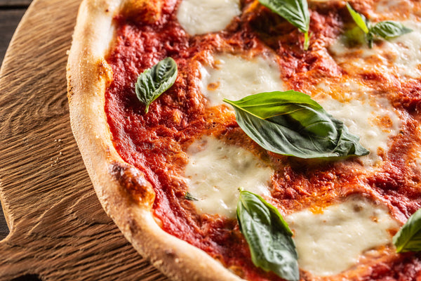 Freshly baked pizza Margherita on a wooden tray