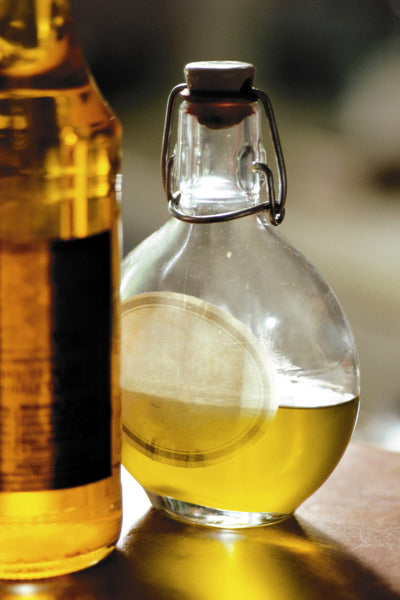 Olive oil in the bottle on the table