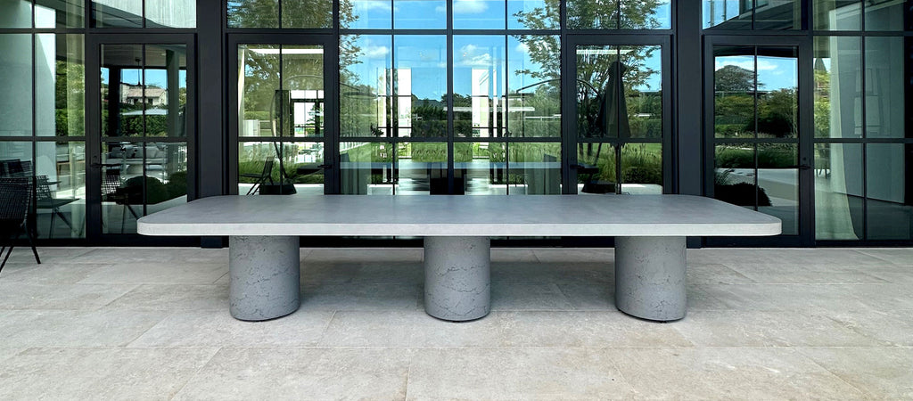 Oversized concrete table sitting outside a commercial building.