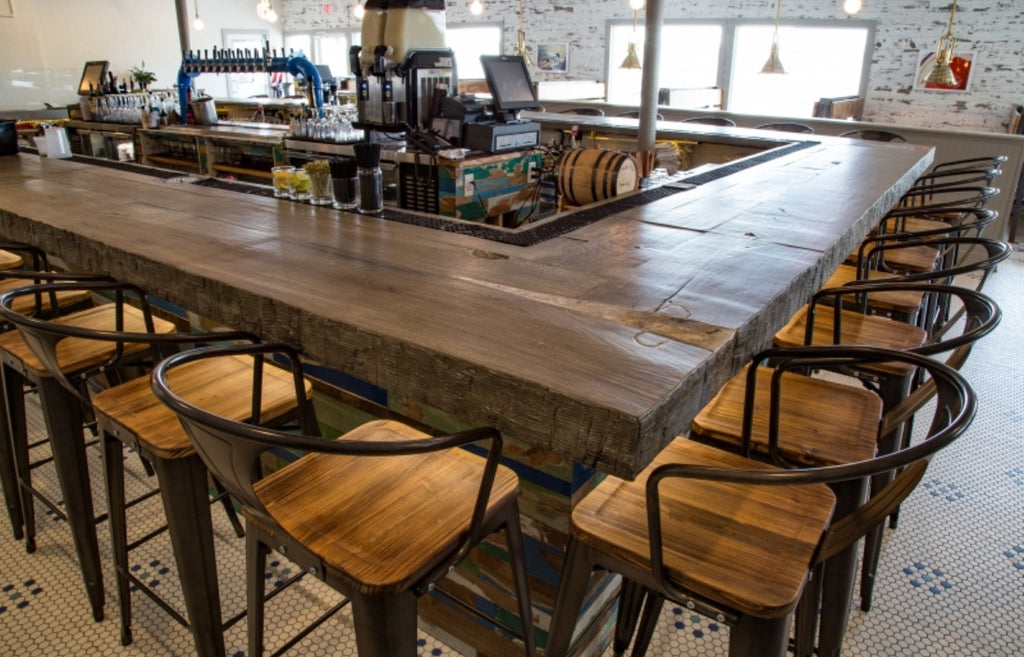 Woodform custom concrete bar in a bright and rustic restaurant.
