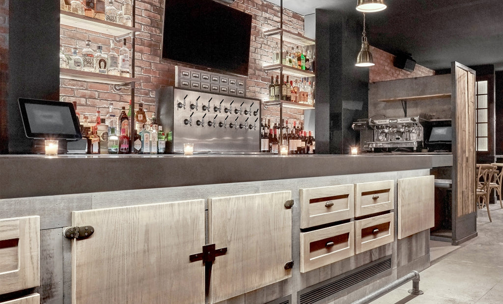 At District Local in NYC, a sleek bar countertop completes the modern aesthetic. 
