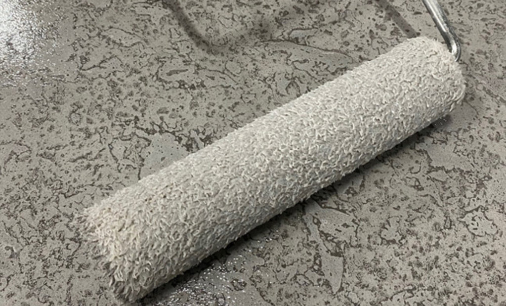 Paint roller on a concrete countertop.