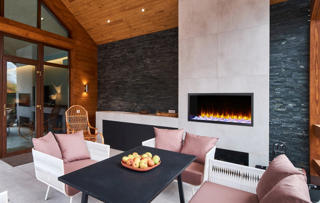 Three seasons room with covered electric fireplace. 