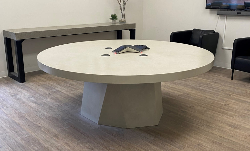 Round concrete office table excellent for collaboration.
