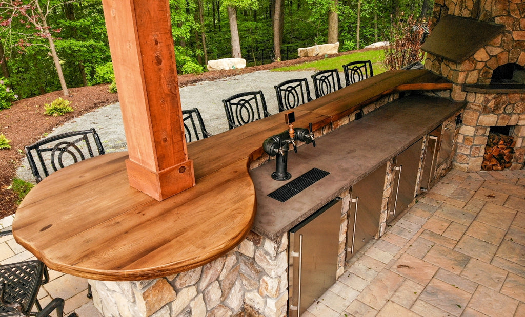 Outdoor kitchen with Woodform wood-look bar top and seating.