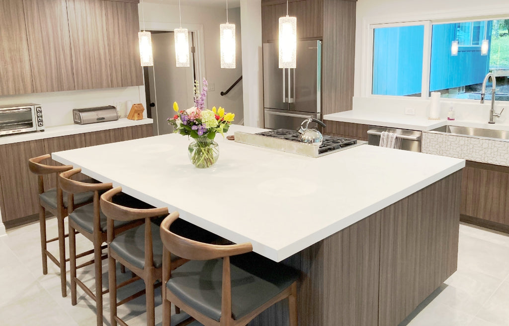 Kitchen with large island in white concrete.