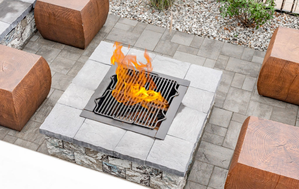 Wood look concrete blocks double as seating around a recessed firepit.