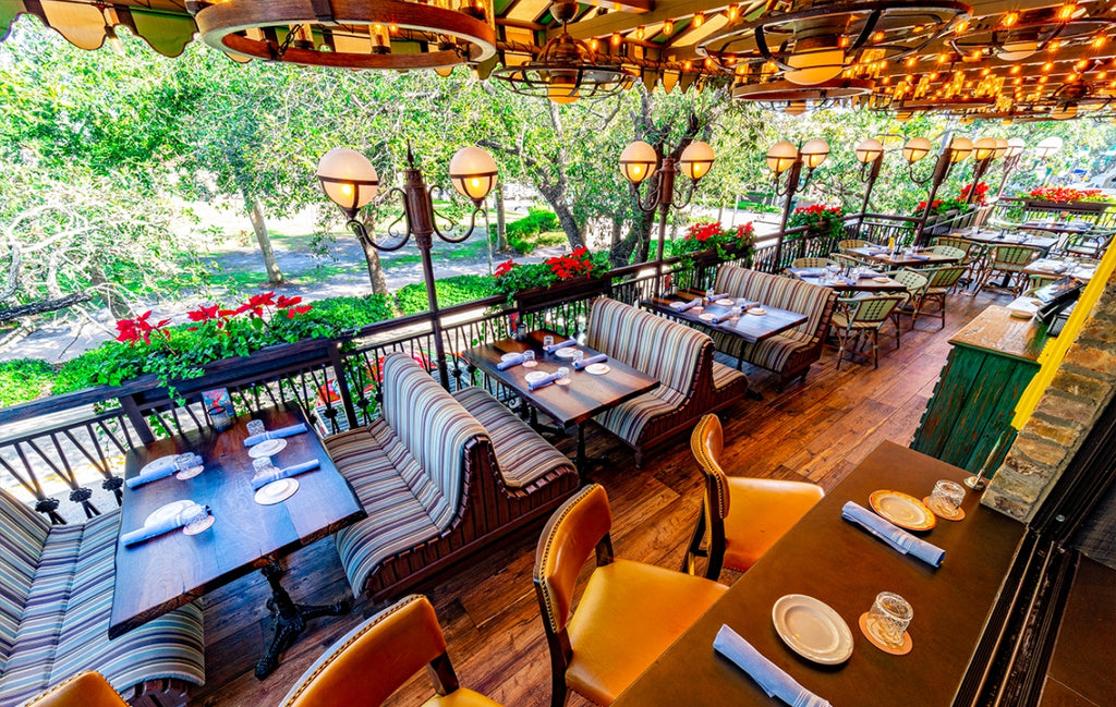 Outdoor seating area for a restaurant with wood look concrete tables.