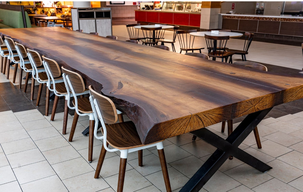Large concrete wood look dining table in a spacious restaurant.