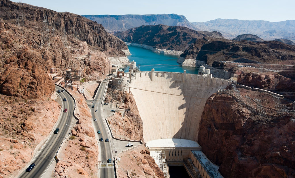 A large dam made of concrete in a canyon.