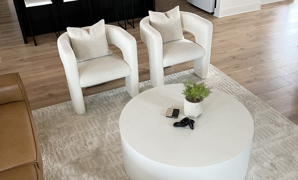 Circular concrete coffee table in a modern style living room.