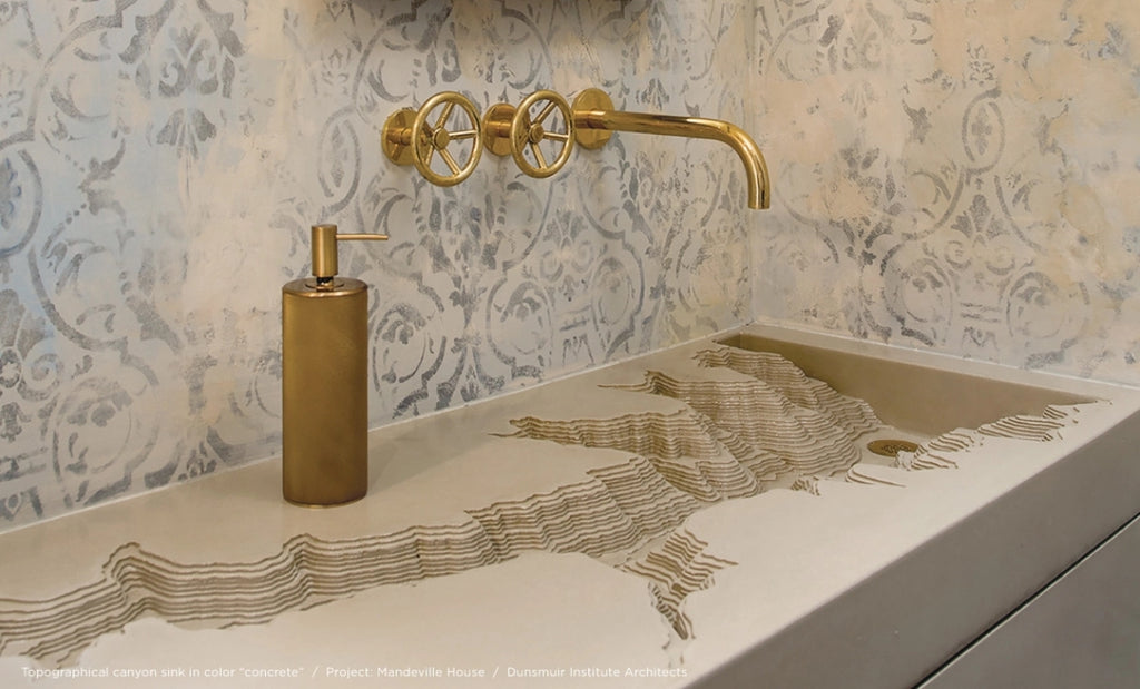 Topographic canyon sink in concrete in an upscale bathroom.